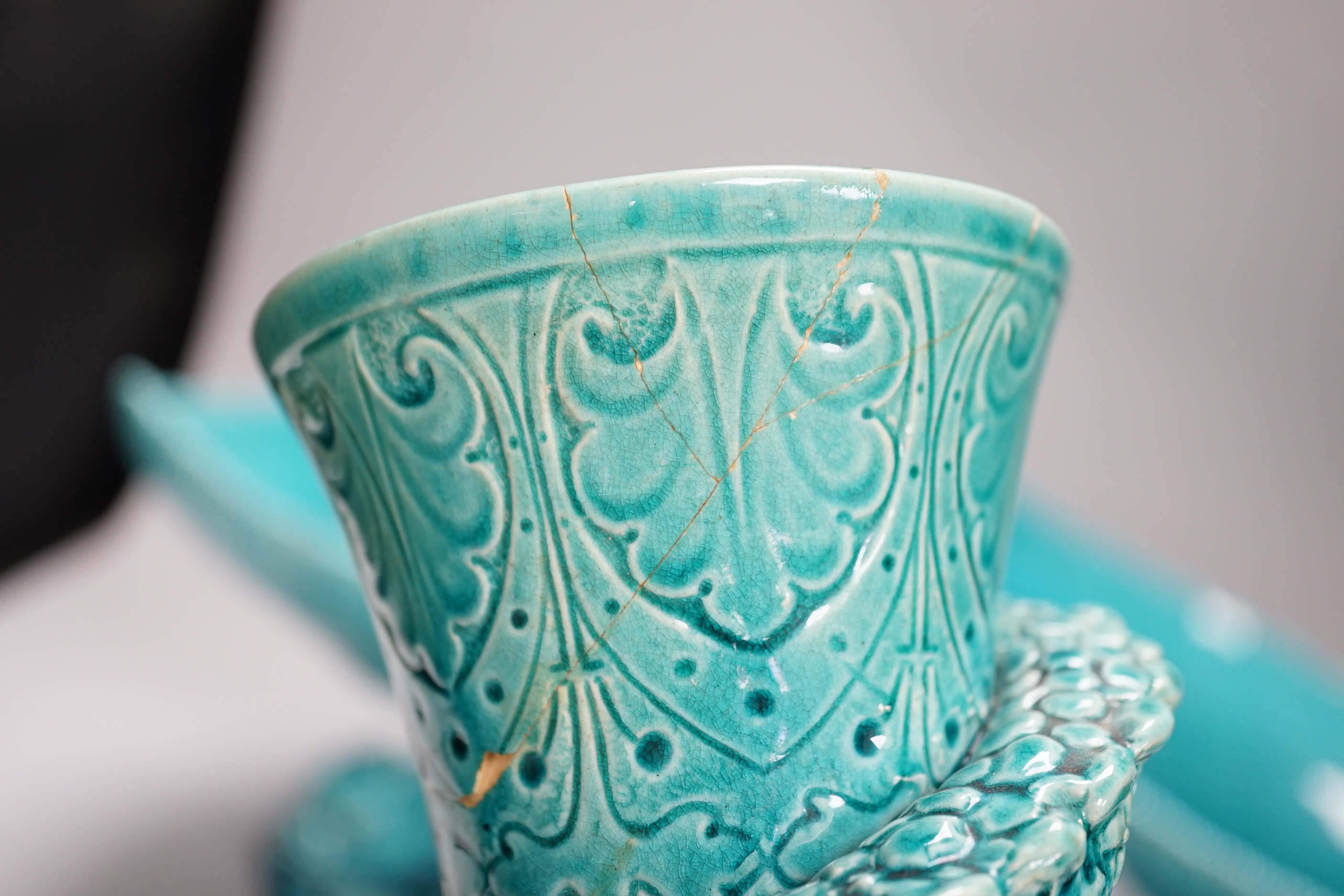 A pair of Burmantofts ‘dolphin’ pedestal bowls and a similar ‘dragon’ vase, 30cm
